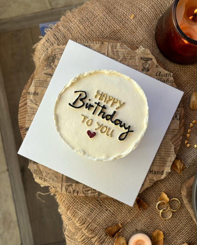 simple tiered vanilla cake for borthday. Happy birthday to you written on top.