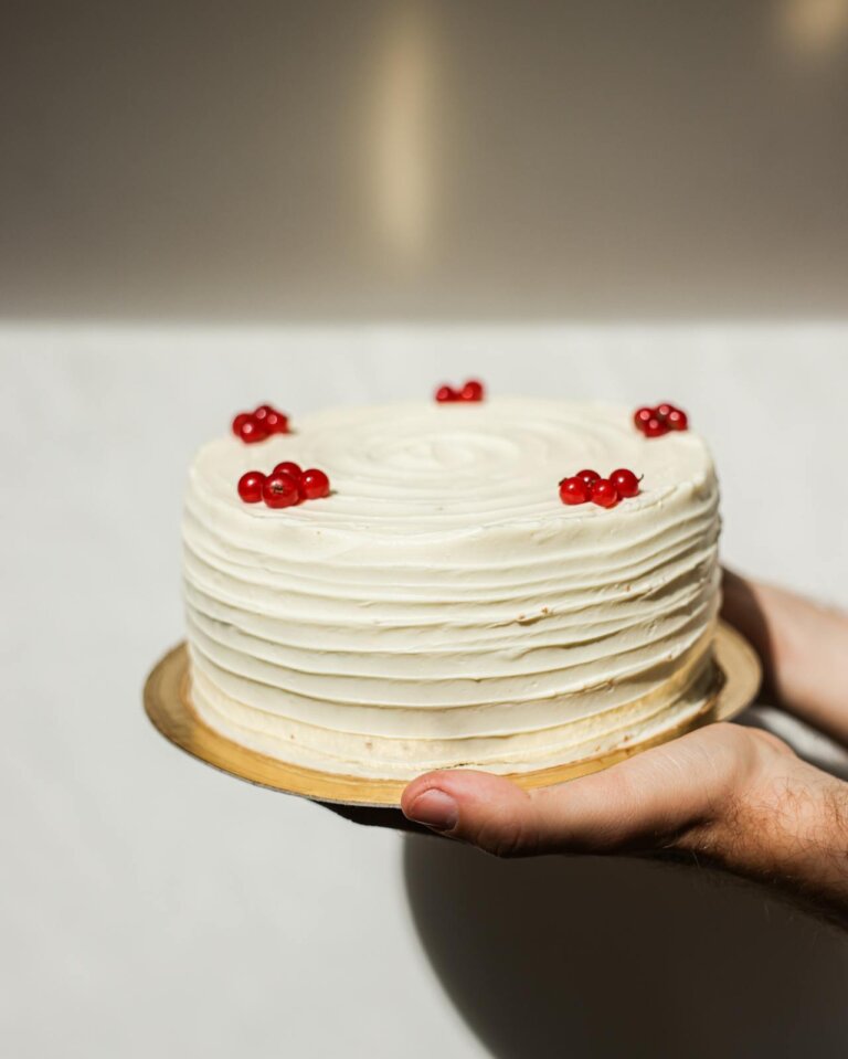 white vanilla cake with cherries on top